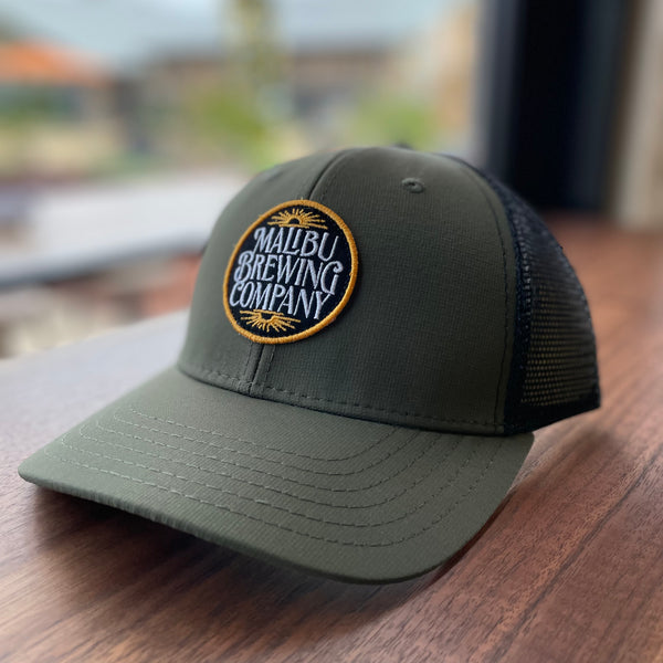 Olive green with black mesh back trucker hat with Malibu Brewing Company embroidered patch
